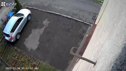 a car parked in a puddle of water in a parking lot at Apartmán Albreit in Jáchymov
