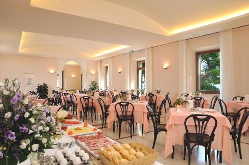a banquet hall with tables and chairs with food at Hotel Bel Sit in Senigallia