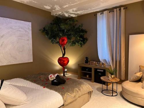 A bed or beds in a room at Loving room cocooning avec jacuzzi « la terre »