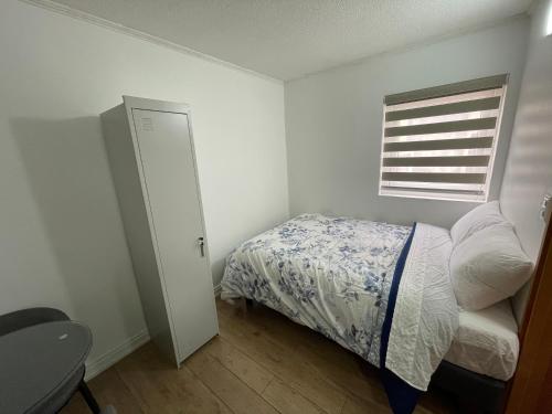 Un dormitorio pequeño con una cama y una ventana. en TinyApartments - estudio pleno centro Concepción, en Concepción