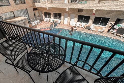 a view of a swimming pool from a balcony at Red Sea Hotel in Eilat