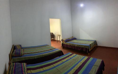 a room with two beds in a room at Coco Garden Holiday Homes in Anuradhapura