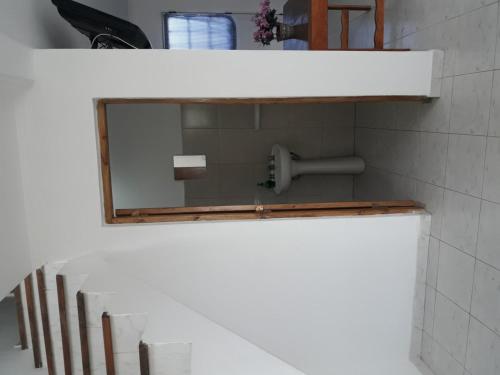 a mirror on a wall in a bathroom at DptosECONOMICOS2 in Necochea
