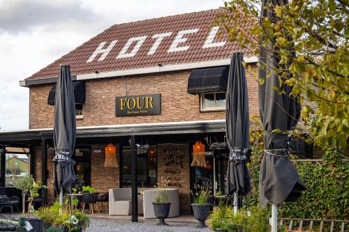 a row of umbrellas in front of a restaurant at Hotel Four in Geldrop