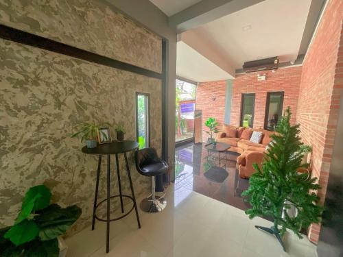 a living room with a brick wall at Tall Tree Kata Phuket in Kata Beach