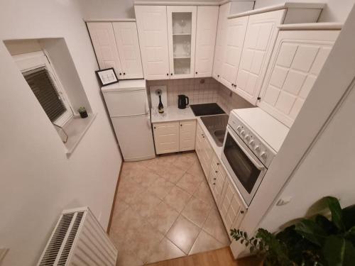 an overhead view of a kitchen with white cabinets at Little cozy apt close to centre in Ljubljana