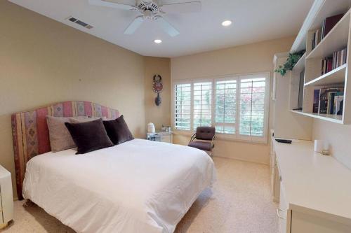a bedroom with a white bed and a window at PGA306 Roomy Single Story PGA West 3 Bedroom in La Quinta