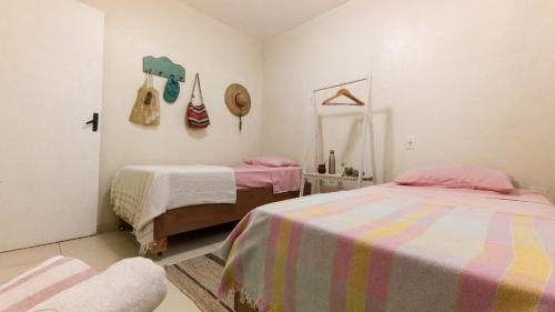 a bedroom with two beds and a mirror at Casa Familiar Estaleiro in Balneário Camboriú
