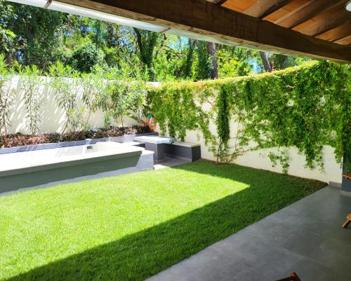 a garden with a pergola and a lawn at Hotel Oasis-Dream Holidays - La Petite France in San Bernardino