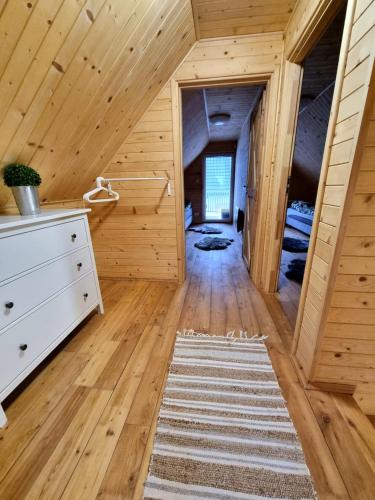 a room with wooden walls and a wooden floor at Fuledzki Biały Domek - Mazury, Jacuzzi, Sauna, Giżycko in Fuleda