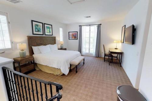 a bedroom with a bed and a desk in a room at SV006 Secluded Spa Villa Studio at LQ Resort in La Quinta