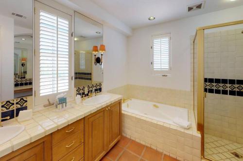 a bathroom with two sinks and a tub and a shower at SV006 Secluded Spa Villa Studio at LQ Resort in La Quinta
