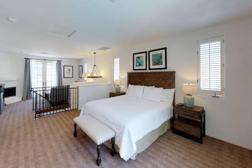 a bedroom with a large white bed and a chair at SV006 Secluded Spa Villa Studio at LQ Resort in La Quinta