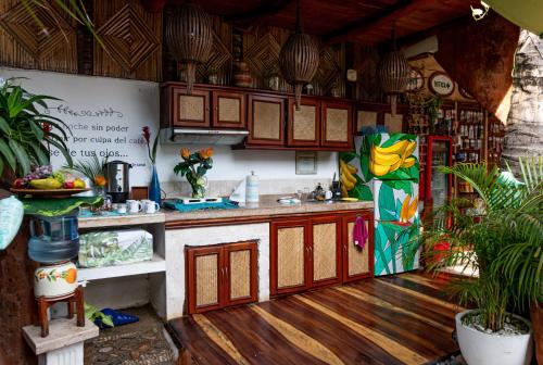 a kitchen with wooden cabinets and a refrigerator at Monyoli Hotel & Boutique in Acapulco
