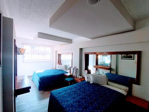 Postel nebo postele na pokoji v ubytování Hotel Mina