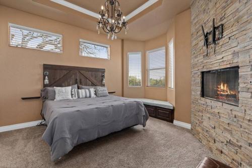 a bedroom with a large bed and a fireplace at Lakeview Villa-we have boat rentals too! in Canyon Lake