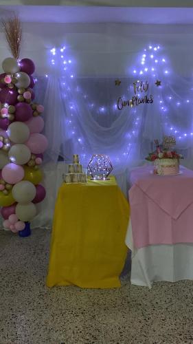 a party with a table and balloons and a sign at Hotel Villa Ricaurte in Girardot