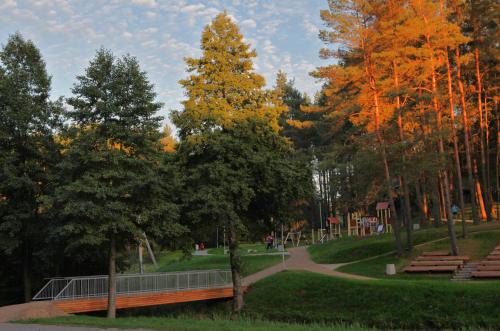 a park with a tennis court and a playground at Vila Kelmyne in Molėtai