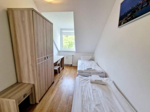 a small room with two beds and a desk at Charming apartment in the center of Berlin 2142 in Berlin