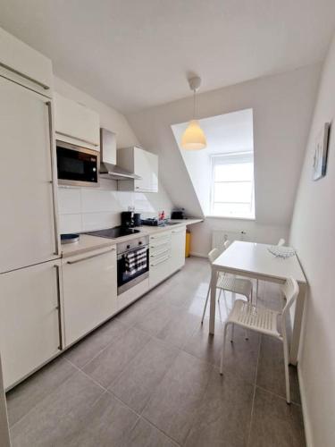 a kitchen with a table and a white refrigerator at Charming apartment in the center of Berlin 2142 in Berlin