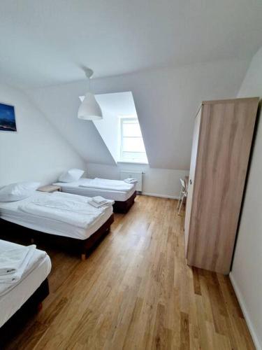 a room with three beds and a window at Charming apartment in the center of Berlin 2142 in Berlin