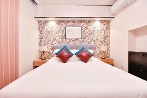 a bedroom with a large white bed with two pillows at BRUCE HOUSE - Vacation STAY 9370 in Izumi-Sano