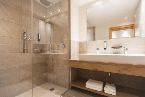 a bathroom with a sink and a shower at Apartement Almhof Fiss in Fiss