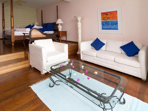 a living room with a couch and a coffee table at Blue Haven Hotel - Bacolet Bay - Tobago in Scarborough