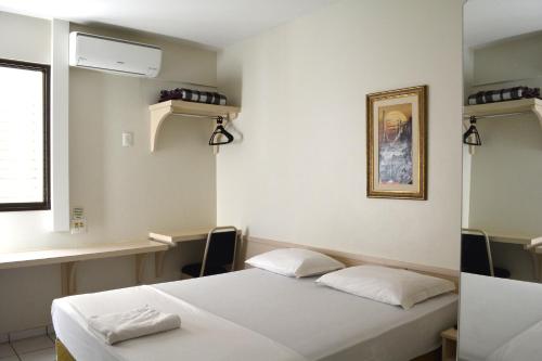 a hospital room with two beds and a window at Sara Palace Hotel in Uberlândia