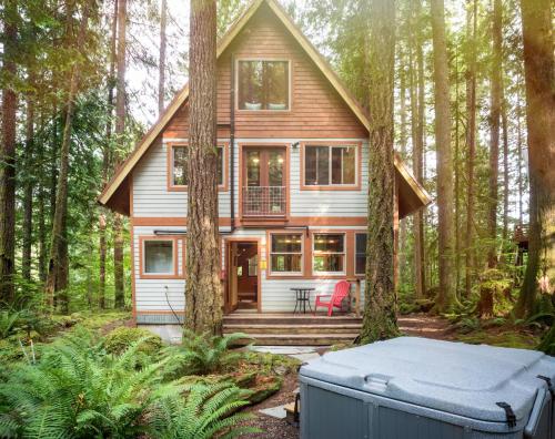 a house in the woods with a mattress in front of it at Treetop Hideaway, Sleeps 2 in Glacier