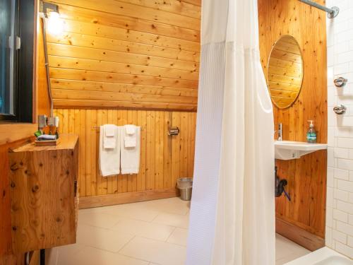 a wooden bathroom with a shower and a toilet at Treetop Hideaway, Sleeps 2 in Glacier