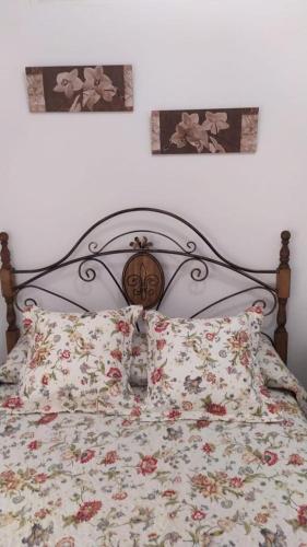 a bedroom with a bed with a floral bedspread at Cortijo las lagunillas in La Puerta de Segura