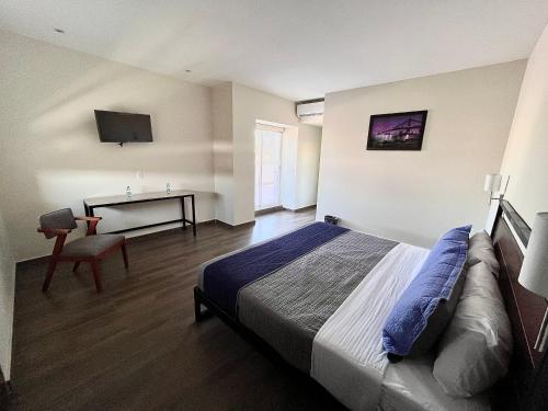 Hotel Refugio tesisinde bir odada yatak veya yataklar
