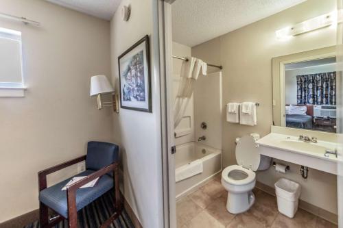 a bathroom with a toilet and a sink and a tub at Studio 6 Greensboro NC I40 in Greensboro