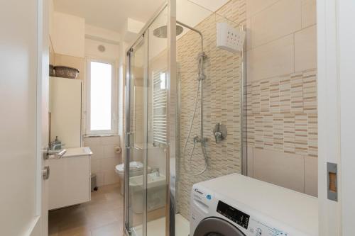 a bathroom with a shower and a washing machine at [Luxury apartment near Navigli] Carlo D'adda 29 in Milan