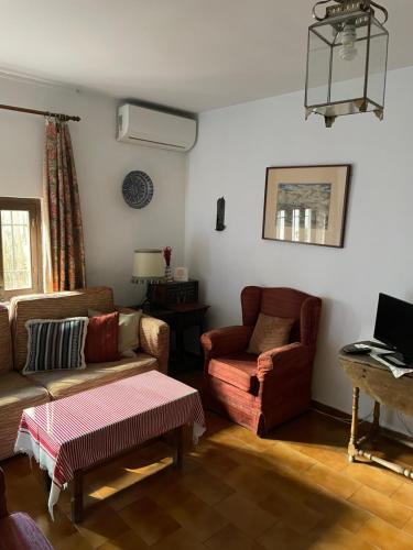 a living room with a couch and a chair at La Casita del Corralon in Granada