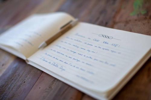a book with a letter sitting on top of a table at Chalet White Wolf SPA at Fiddler's Lake in Mille-Isles