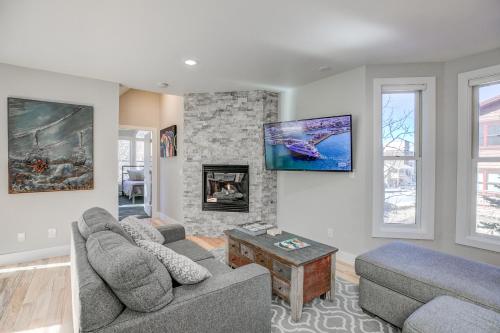 a living room with two couches and a tv at Just Walk Inn Townhome: Stroll To Main St, Gondola in Breckenridge