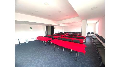 a large room with red chairs and a room with at Hotel Boutique Palacete in Bogotá