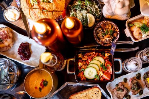 a table filled with many different dishes of food at Boutique Hotel Elburg met Tapperij in Elburg