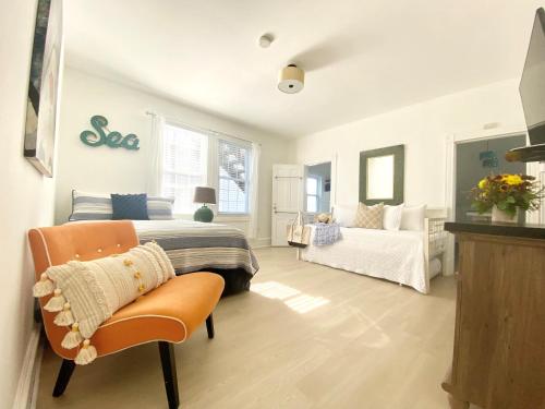 a bedroom with a bed and a couch at Windward at the Beach in Beach Haven