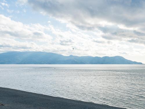 a large body of water with mountains in the background at SUIHOUEN in Numazu