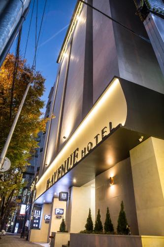 a building with a sign on the side of it at H Avenue Hwamyeong in Busan