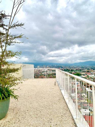 a view of a city from the balcony of a building at Único Apartamento en Nuevo y Moderno Condominio in San José