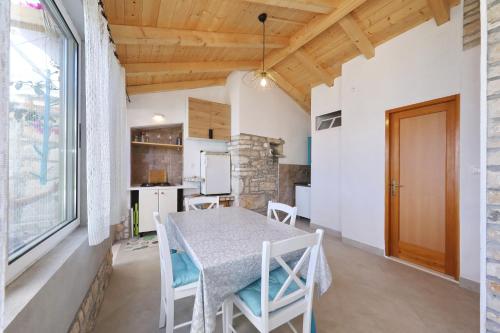 a kitchen and dining room with a table and chairs at Secluded fisherman's cottage Cove Stiniva, Korcula - 11389 in Vela Luka