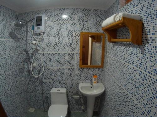 a small bathroom with a toilet and a sink at Maafushi View in Maafushi