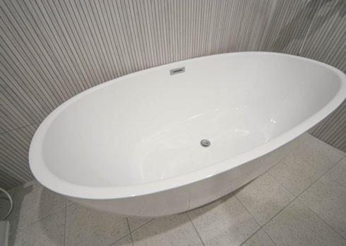 a white toilet in a bathroom with a wall at H Avenue Hwamyeong in Busan