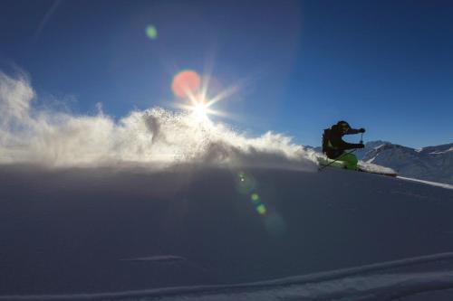 a person is skiing down a snow covered slope at Apart Sportiva in Klösterle am Arlberg