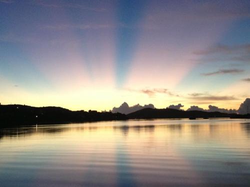 a view of a lake at sunset at Naniqui Cottage - Only Adults -Parking Golf Car Only in Culebra