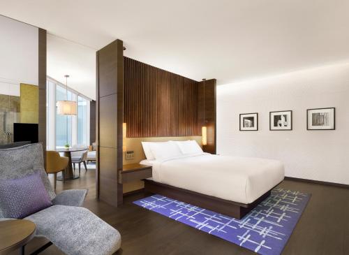 a hotel room with a bed and a chair at Park Hyatt Seoul in Seoul
